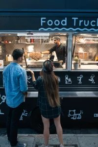 People waiting on food from a food truck