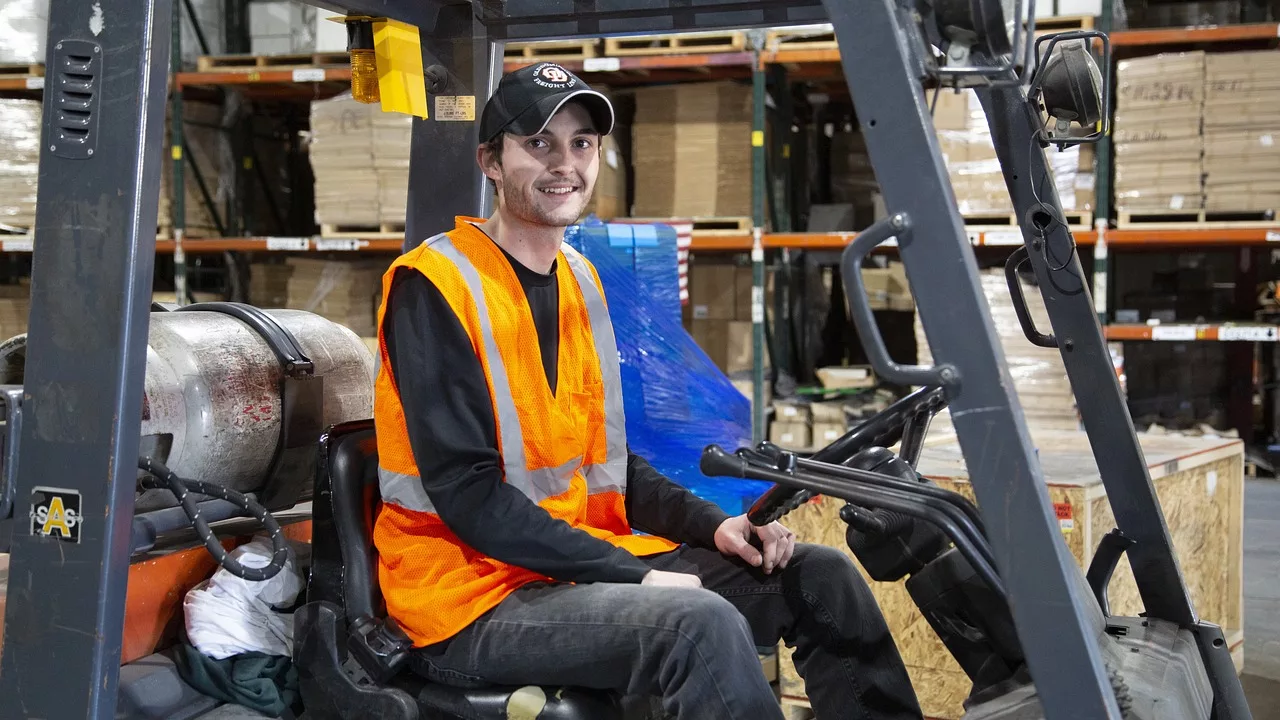 Image of a person operating a propane powered forklift