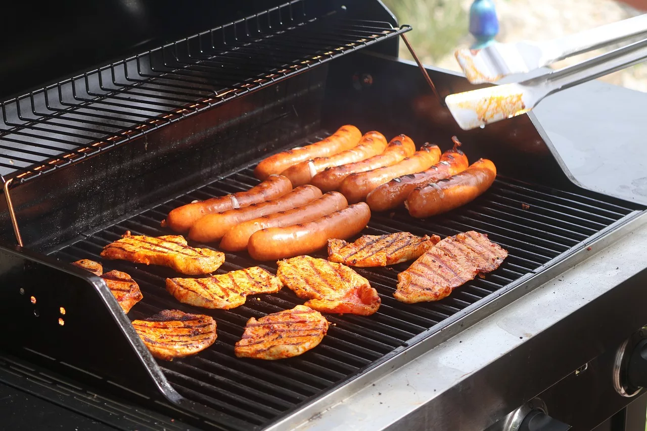 Hot dogs and chicken on a propane powered grill